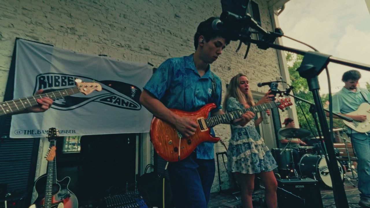 Cooper Delo playing guitar at Chi Phi