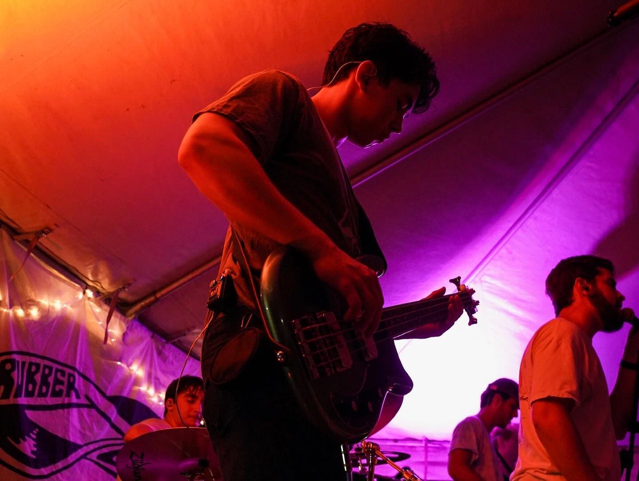 Cooper playing under a lit tent