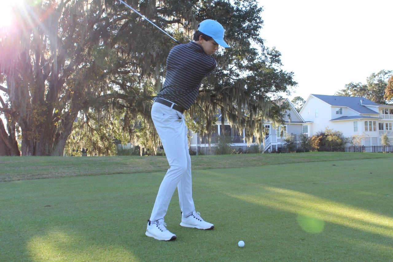 Cooper at the top of his golf backswing