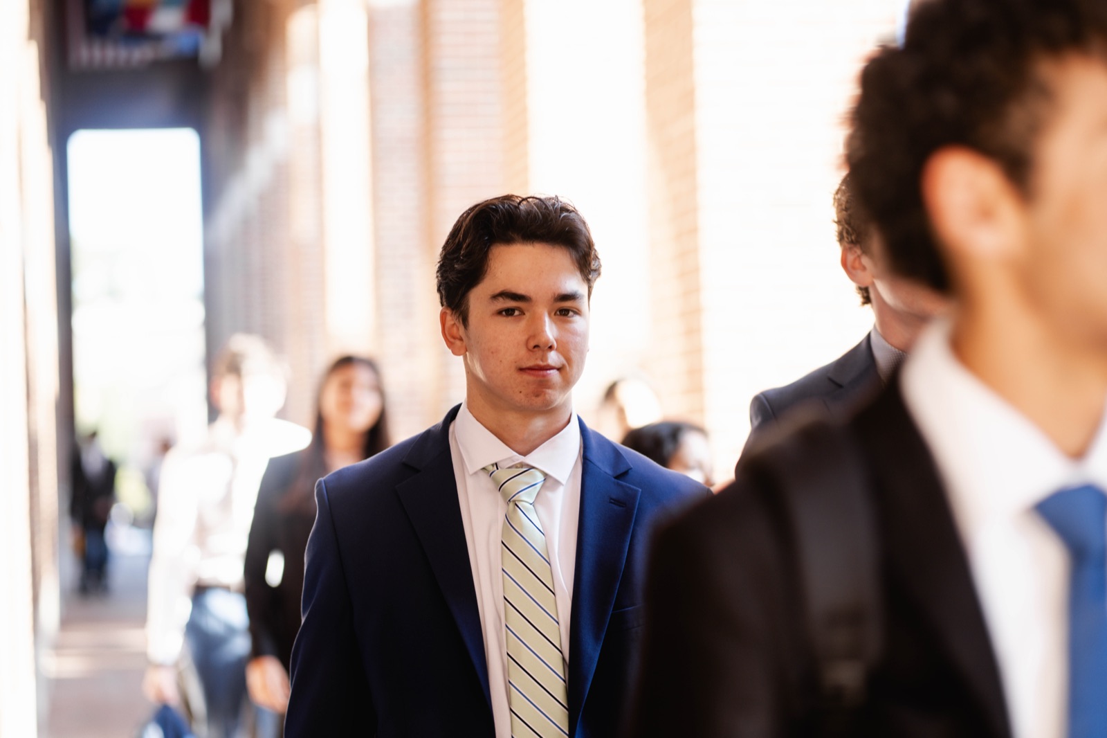 Cooper in suit on campus